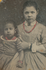 Daguerreotype of two young girls, the older of the two holding the other protectively.