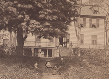 19th century photograph of the Cherry Hill household sitting in front of the house at different levels.